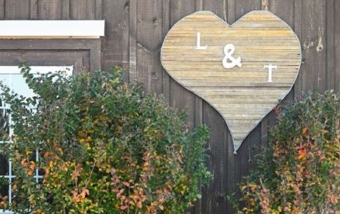 The initials of the bride and groom adorn the reception barn